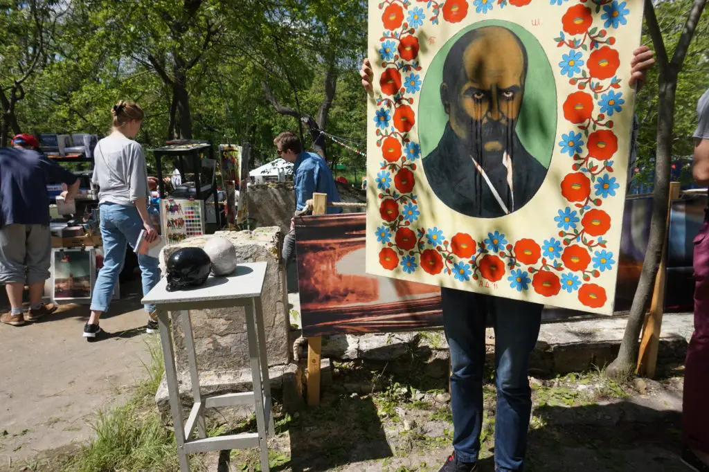 People searching through budget art pieces at a garage sale.