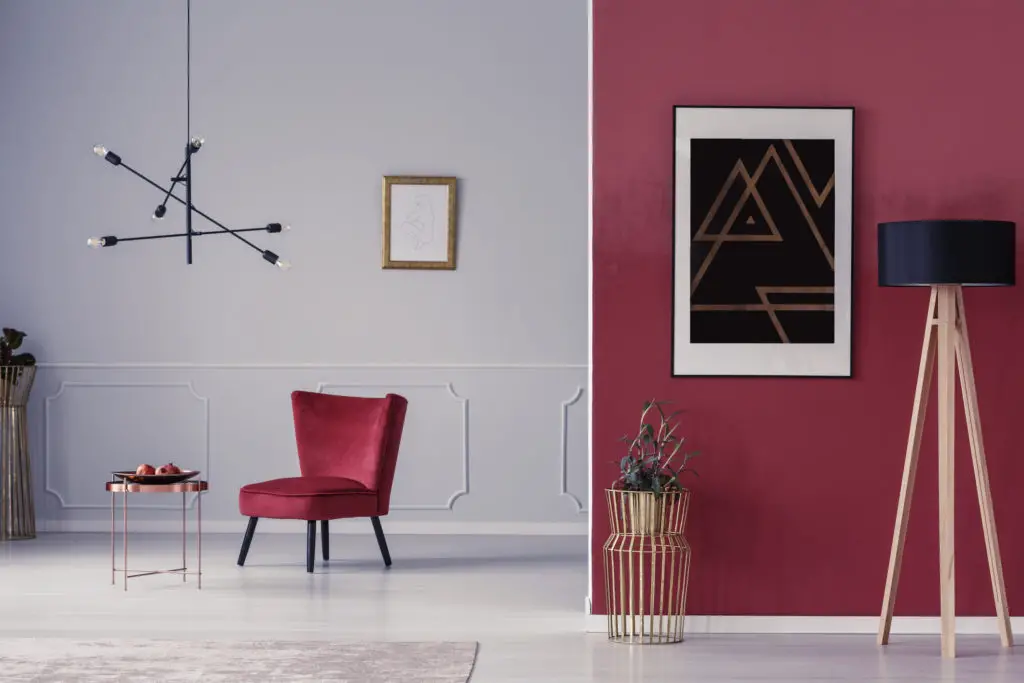 Room with art on walls lit by lamps.