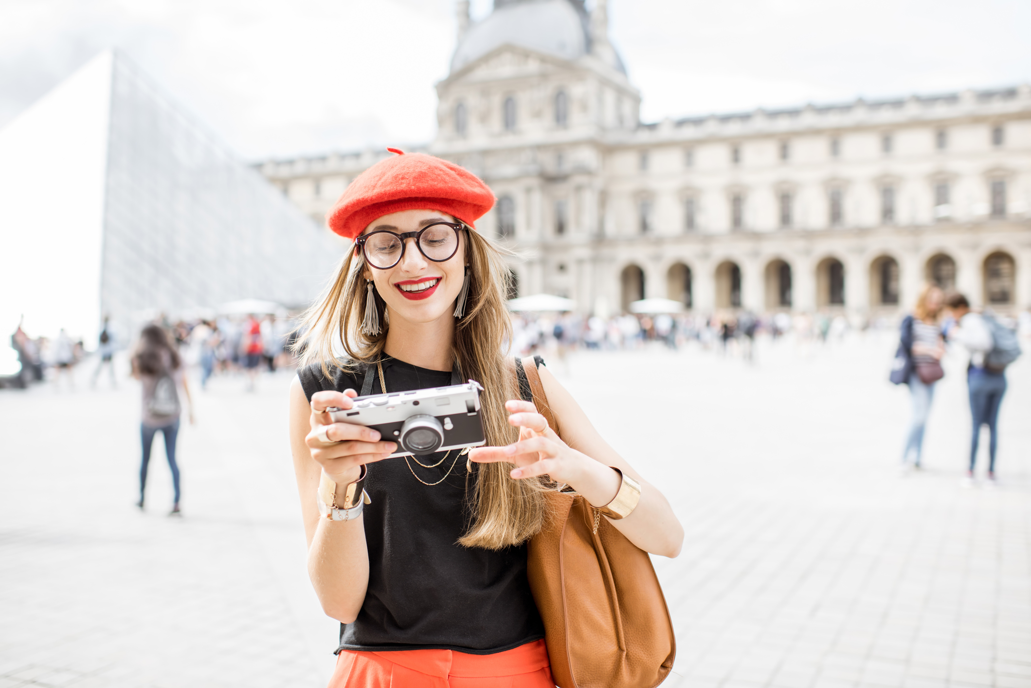 Woman at The Louvre Museum having just learned how to photograph paintings