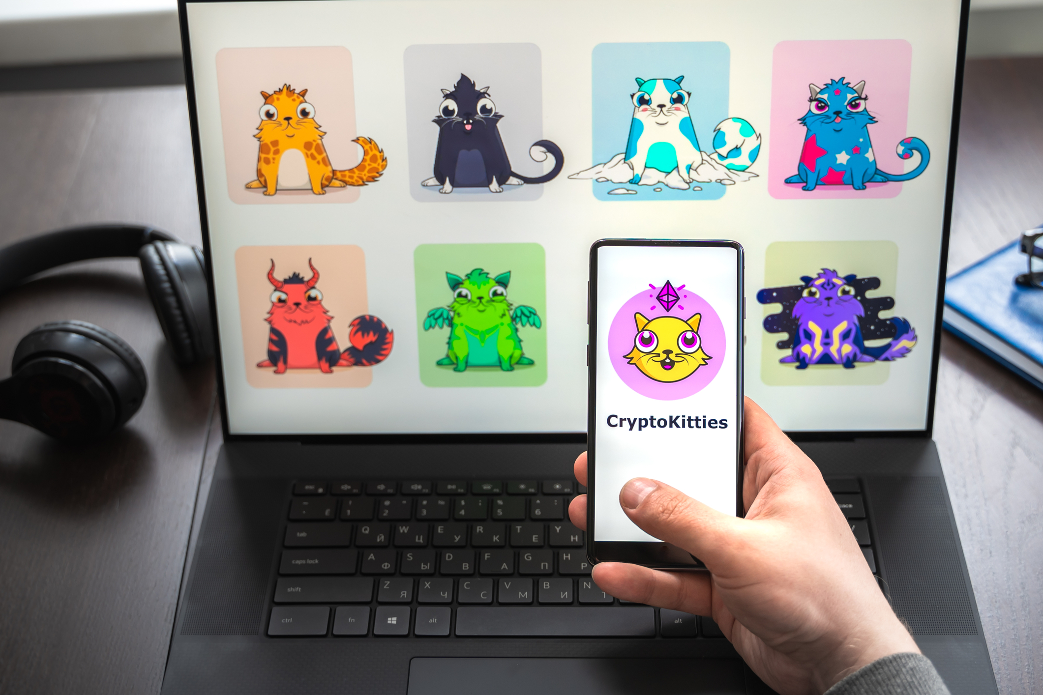 Man holding phone taking a screenshot of an NFT.